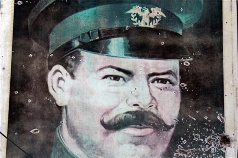 The bullet-riddled portrait of Mexican revolutionary hero Gen. Francisco Villa stands outside the El General restaurant in Ciudad Mier, Mexico, on the border with Texas. The residents of Ciudad Mier have been under siege for months as powerful drug cartels battle for control of a prime drug smuggling corridor. 